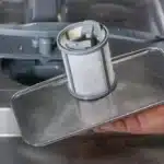 how do i clean the dishwasher filter in kenmore model 587 161 49401